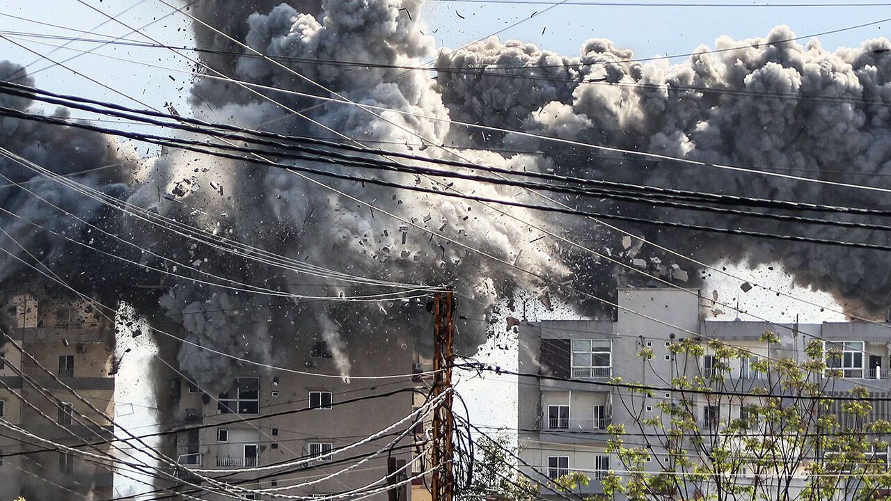 Smoke and debris rise after a building is hit by an Israeli airstrike in the Lebanese city of Tyre