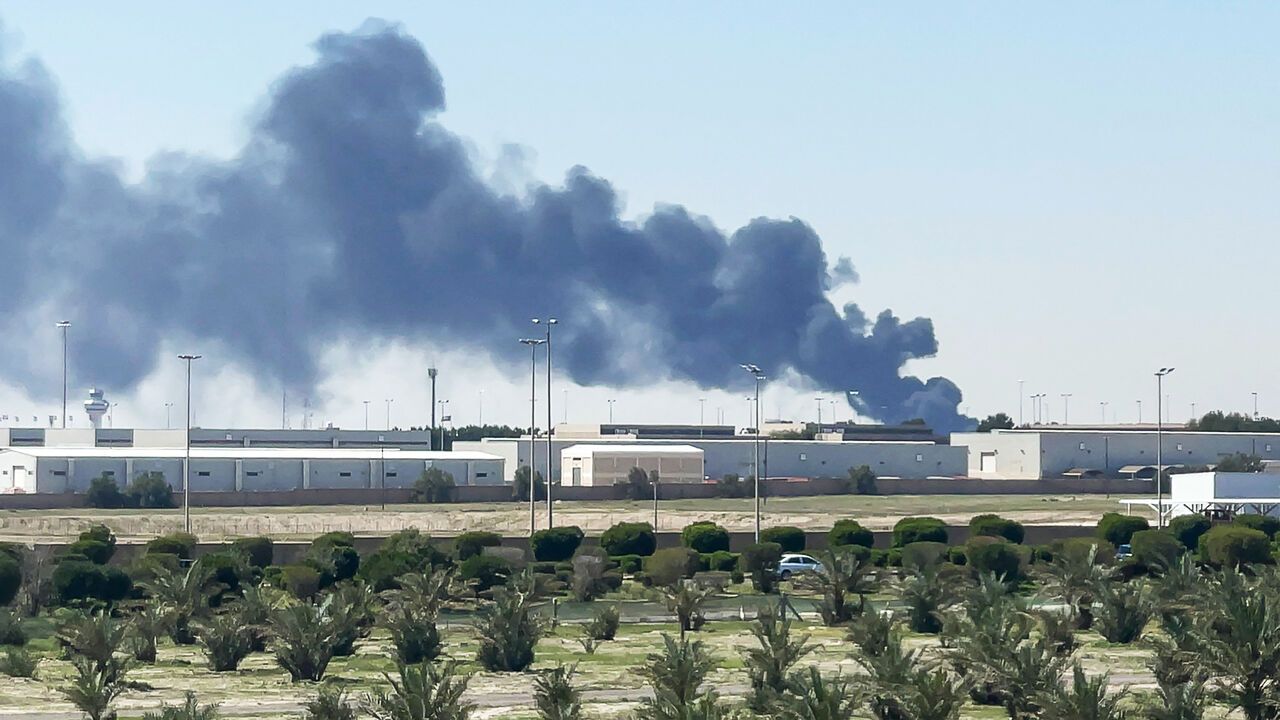 Smoke rises from an area of Kuwait's international airport after a drone strike.